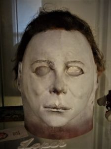 This is a Michael Myers Halloween mask that is white and he has brown hair
